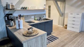 Fridge, stovetop, dishwasher, coffee/tea maker