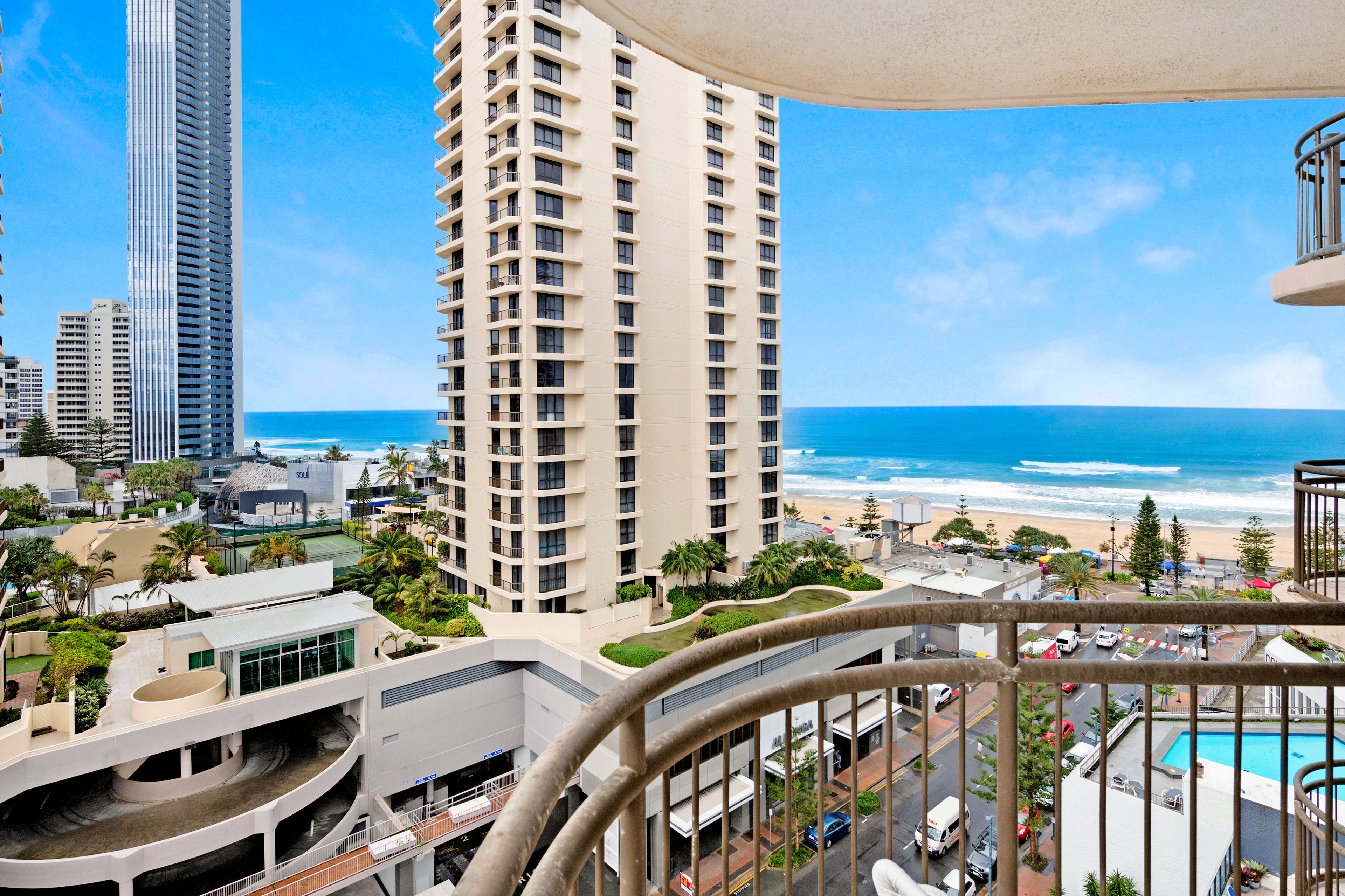 A high-rise building with a view of the beach and ocean.