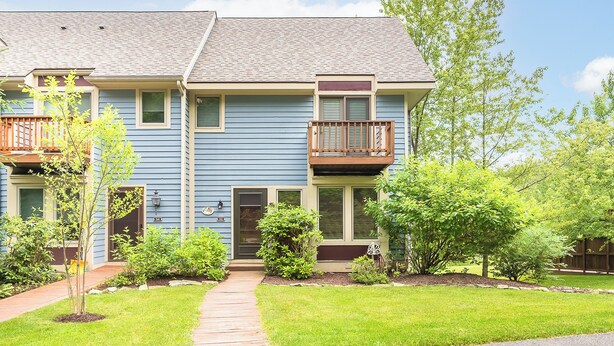 A two-story residential building with a front porch, a small balcony on the second floor, and a well-maintained lawn. - Beary Relaxing by Taylor Made Deep Creek (McHenry)