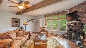 A cozy living room with a sofa, coffee table, and fireplace. - Beary Relaxing by Taylor Made Deep Creek (McHenry)