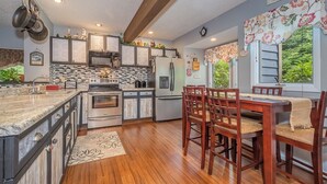 A kitchen with granite countertops, stainless steel appliances, and wooden cabinets. - Beary Relaxing by Taylor Made Deep Creek (McHenry)