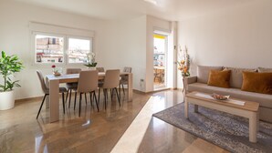 A modern living room with a dining area, a sofa, and a coffee table. - Holiday Apartment "Palma De Mallorca 12" with Private Terrace, A/C & Wi-Fi (Torremolinos)