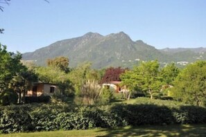 Escape to a serene mountain retreat surrounded by lush gardens and a peaceful atmosphere.