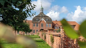 A large brick building with a prominent tower and a clock.