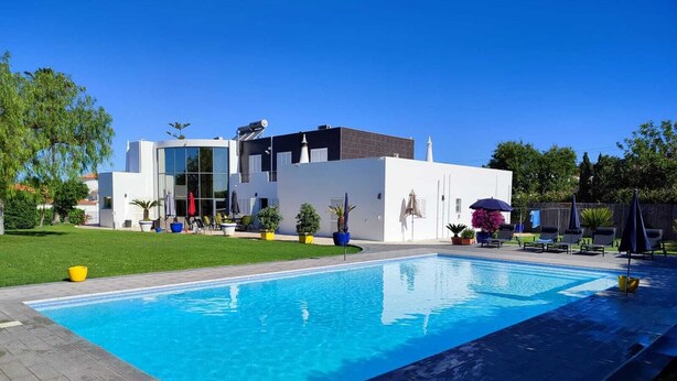 A modern house with a swimming pool, a well-maintained lawn, and outdoor seating. - PRIVATE VILLA WITH POOL IN THE ALGARVE AT OLHAO NEAR FARO (OLHAO)