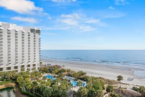 A beachfront hotel with multiple floors, a swimming pool, and a beach view. - N Hampton 907 in Kingston, Oceanview, Pool, Beach (Myrtle Beach)