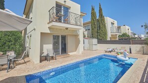 A residential building with a swimming pool, a balcony with outdoor furniture, and a clear blue sky. - Protaras Holiday Villa Cl19 (Paralimni)