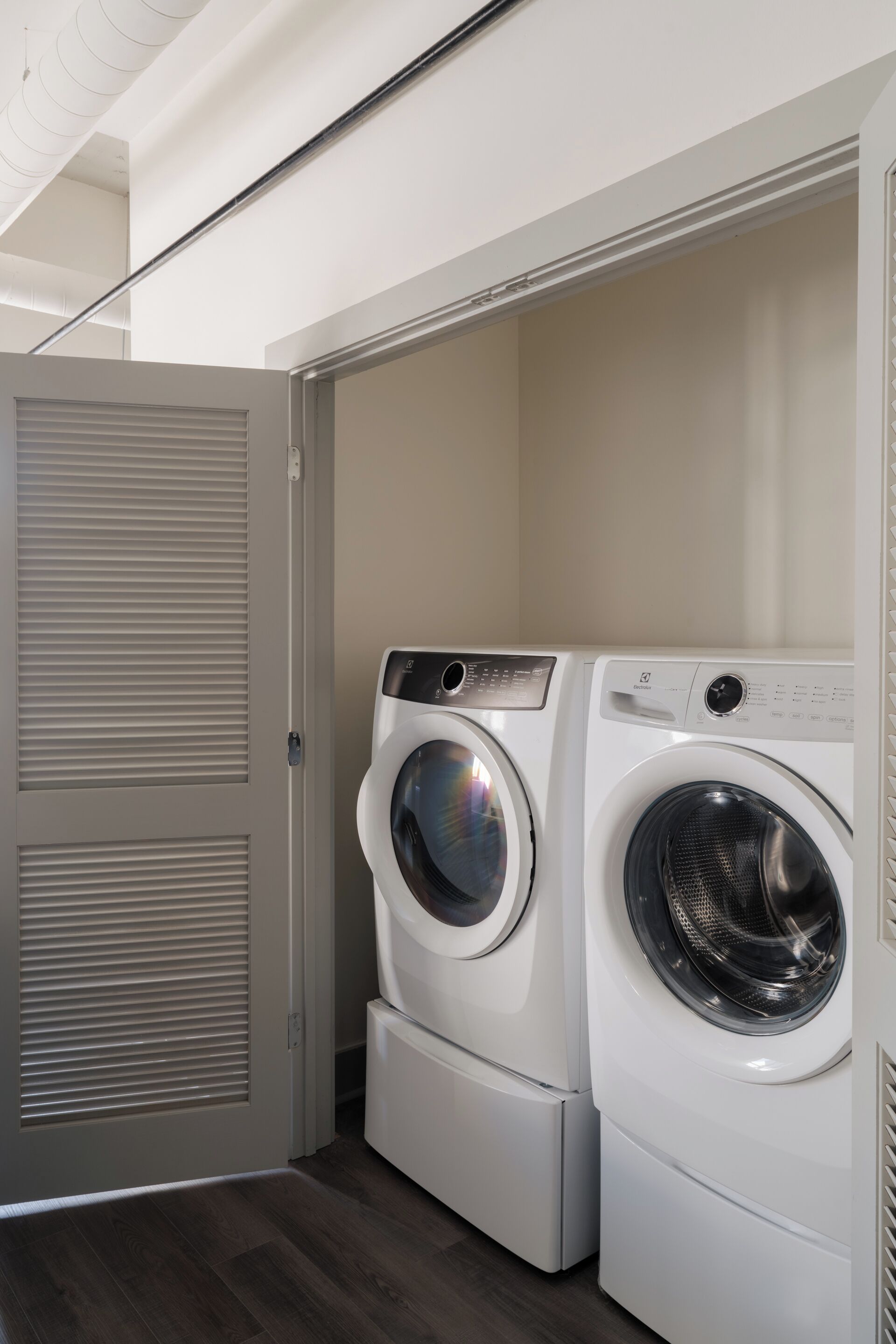 A laundry room with two stacked front-loading washing machines.