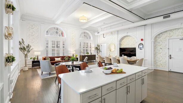 A spacious living room with a large island, a fireplace, and a dining area with multiple chairs. - Kasa Capitol Hill Downtown Nashville (Nashville)