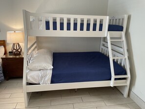 A bunk bed with a blue mattress and white bedding. - Heated Pool, King Bed, Bunk Bed, Huge TV, Marina, Tiki Bar & Grill (Sarasota)