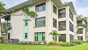 A multi-story building with a flat roof, large windows, and a well-maintained lawn. - NEW NEW   Burnt Store Marina Front,  Premier Corner Unit, 30-Day Minimum Retreat (Punta Gorda)