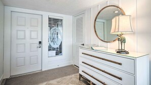 A clean, modern bathroom with a white vanity, a round mirror with a gold frame, and a decorative lamp. - NEW NEW   Burnt Store Marina Front,  Premier Corner Unit, 30-Day Minimum Retreat (Punta Gorda)
