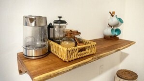 A wooden shelf with a coffee maker, a glass jar, and a woven basket. - Chaim, Happiness to be where you should be. (Campeche)