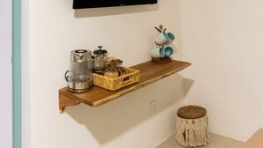 A modern kitchen with a wooden shelf holding kitchenware, a coffee maker, and a decorative item. - Chaim, Happiness to be where you should be. (Campeche)