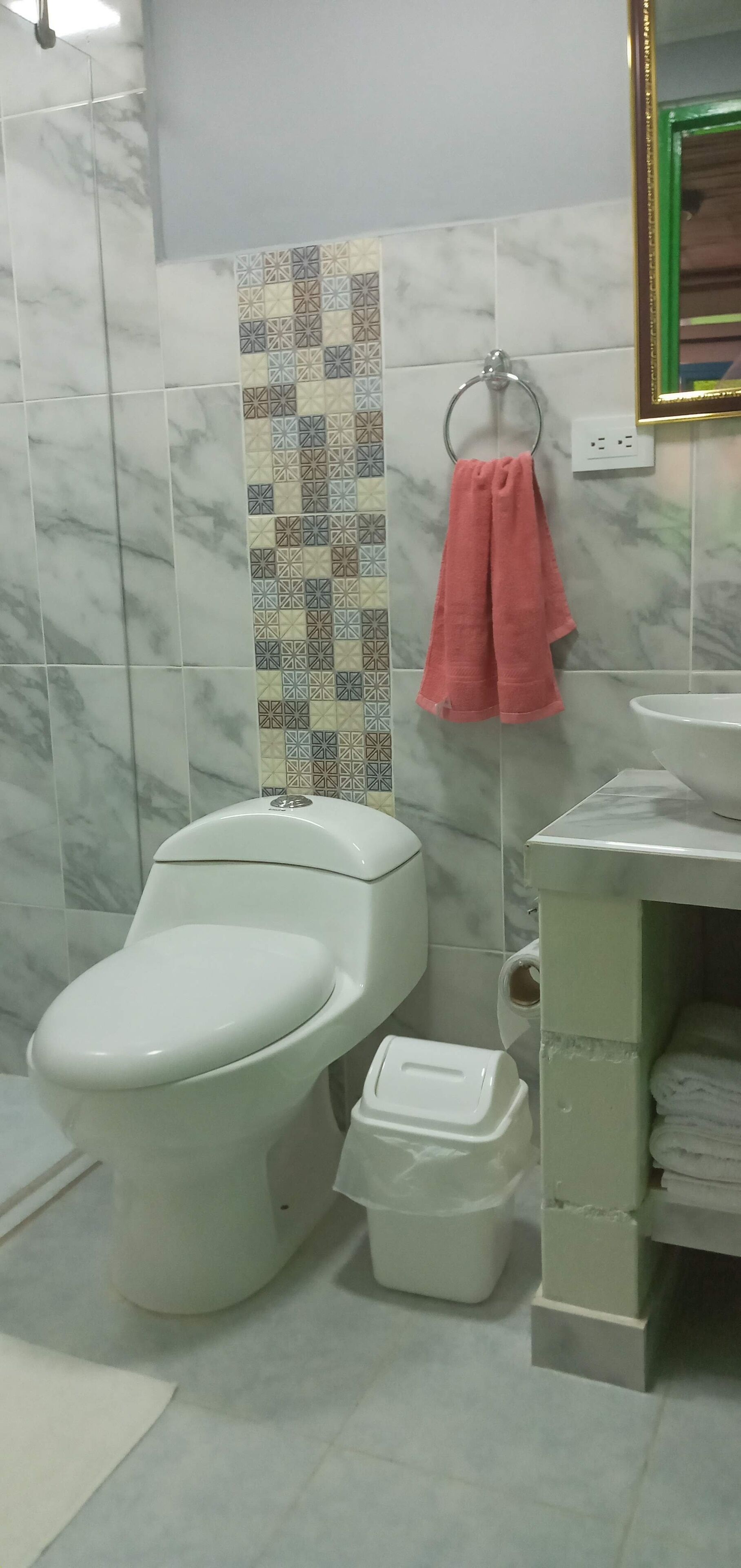 A bathroom with a toilet, bidet, and sink.