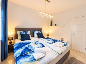 A modern hotel room with a large bed, bedside lamps, a ceiling light, and a door. - Hacienda MATEA – an oasis of romance near the beaches, Pula (Pula)