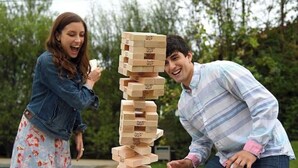 Two people playing a game of Jenga outdoors. - Lake house with hot tub, pool, game room & BBQ grill (Lake Elsinore)