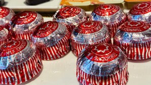 A display of wrapped chocolates and a variety of packaged goods. - Acorn Lodge Gatwick (Horley)