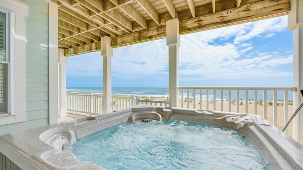 A hot tub with a view of the beach and ocean. - Premier Oceanfront Home w/ Pool, Elevator, Hot Tub, Theater Room (Avon)