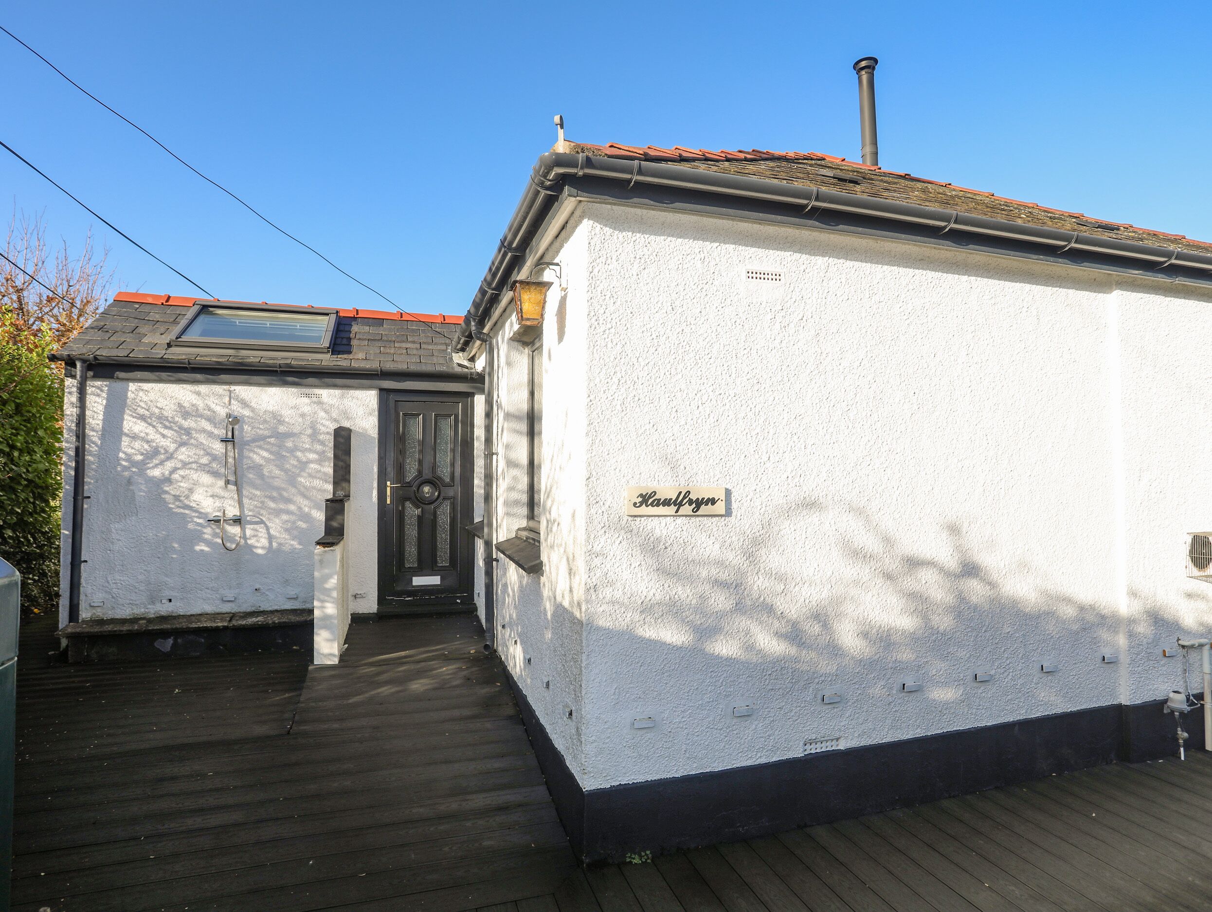 A building with a white exterior, a black door, and a nameplate reading "Kaufyn".