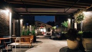 An outdoor patio area with seating and potted plants.
