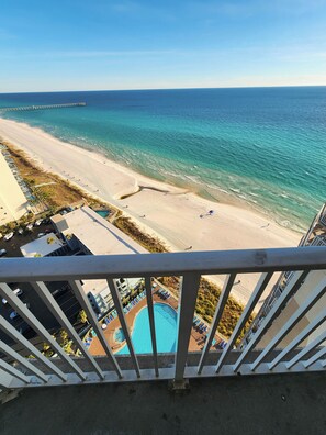 A beach view from a balcony with a pool and lounge chairs. - Exceptional Unit, Fantastic Gulf Views, Ceiling To Floor Windows,Pools! (Panama City Beach)