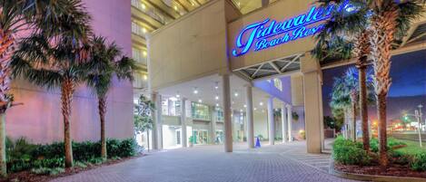 A hotel entrance with a sign reading "Tidewater Beach Resort."
