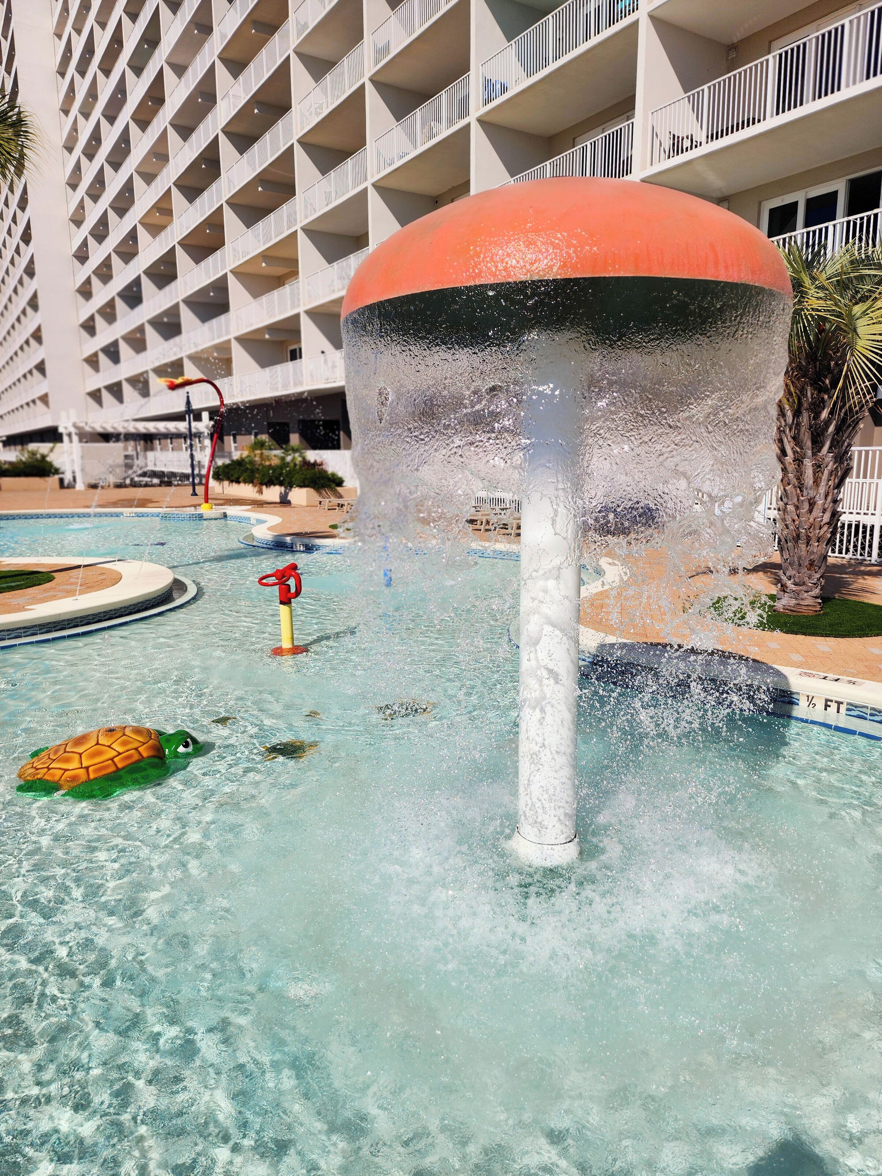 A water feature with a central fountain and a pool.