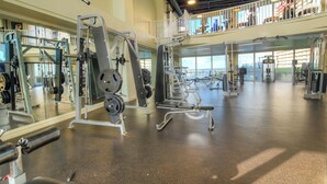 A spacious gym with various exercise equipment, a mezzanine level, and large windows. - Best Location, 3rd floor condo! Enjoy the incredible views and privacy! (Panama City Beach)