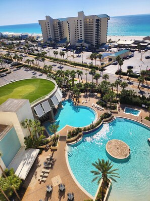 A resort with a large swimming pool, palm trees, and a view of the ocean. - Best accessible unit on 3rd FLOOR! Gorgeous! Convenient! Heavenly! (Panama City Beach)