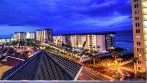 A coastal hotel with multiple high-rise buildings, a parking area, and a view of the ocean. - Bring your Pet! Amazing 2nd floor unit! Outstanding Views and Amenities! (Panama City Beach)