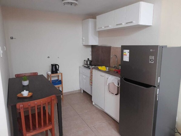 Fridge, microwave, electric kettle, cookware/dishes/utensils