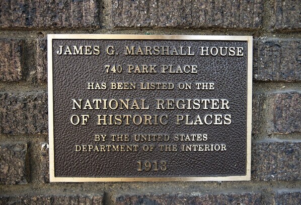 A plaque on a brick wall.