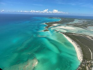 An aerial view of a coastal area with clear turquoise waters, sandy beaches, and dense vegetation. - New Private Pool, Private Beach and Flat, Private House, what else do you need? (Whymms)
