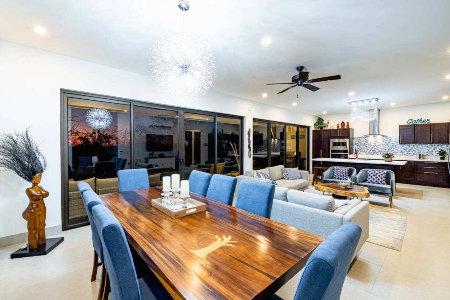 A modern living space with a dining area, a kitchen, and a seating area.