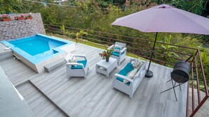 A deck with a pool, white wicker furniture, and a grill. - RIVER VIEW / VILLA FRENTE AL RIO / PEACE BY THE RIVER (Las Guázaras)