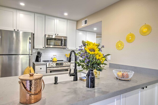 Enjoy cooking in this well-equipped kitchen with a sink, microwave, and stove.