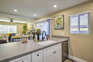 Enjoy cooking in this well-equipped kitchen with a spacious island, sink, and dishwasher.