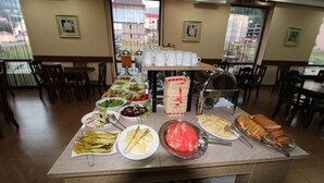 A buffet setup with various food items and utensils. - BakurianiPearl (Borjomi)