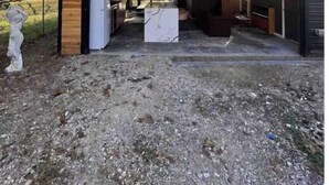 A covered outdoor area with a wooden structure, a white refrigerator, and a marble-topped table. - Guest House | King Bed | Zen Retreat (Irving)