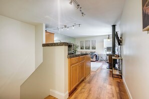 Une cuisine moderne avec des meubles en bois, un plan de travail en granit et un four encastré.