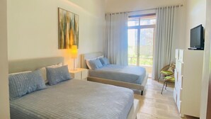 A bedroom with two beds, a TV, and a window with curtains. - 1BR 4 Guests Golf View Course Casa de Campo (La Romana)