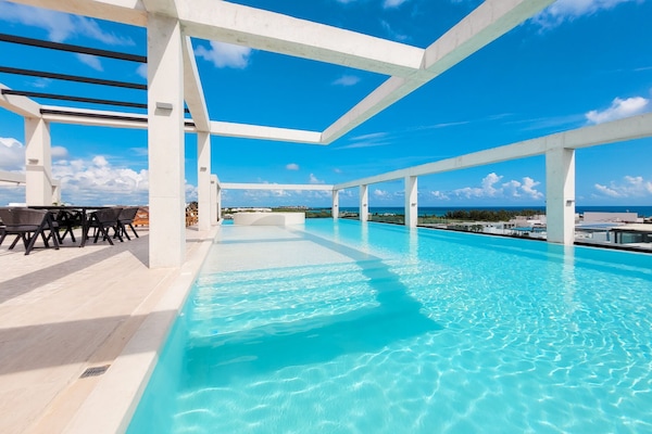 Una piscina al aire libre, tumbonas