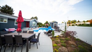 A backyard with a swimming pool, outdoor furniture, and a garden. - The Farmstead- Pool, Hot Tub, Firepit and Farm Fresh Eggs/Animals in Walla Walla (Walla Walla)
