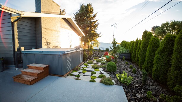 A modern house with a hot tub, a stone pathway, and a well-maintained garden. - The Farmstead- Pool, Hot Tub, Firepit and Farm Fresh Eggs/Animals in Walla Walla (Walla Walla)