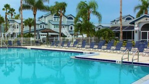 A swimming pool with lounge chairs and palm trees. - Beach Access, Pools, Tennis and Pickleball - 1225 Gulf & Bayside (Siesta Key)