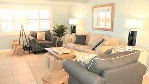 A living room with two sofas, a coffee table, and a lamp. - 303 Sea Shell- Beautifully Updated Gulfside Condo (Siesta Key)