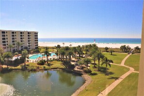 A resort with a pool, beach, and ocean view.