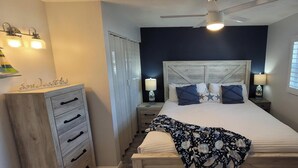 A bedroom with a bed, bedside tables, a dresser, a ceiling fan, and a window with blinds. - Gulf Holiday Unit 12- Close to Beach and Siesta Key Village! (Siesta Key)
