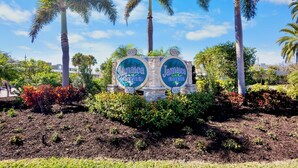 A sign with 'Jamaica Royale' and the number '5830' surrounded by palm trees and shrubs. - Jamaica Royale 099 Nice Gulf side unit! (Siesta Key)